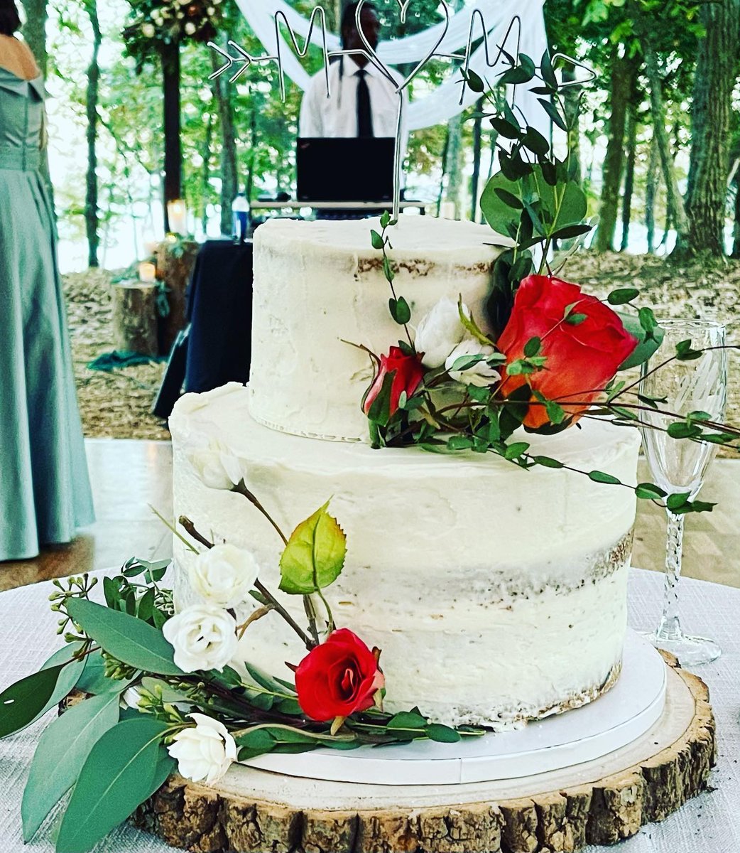 Two tier naked wedding cake with wildflowers